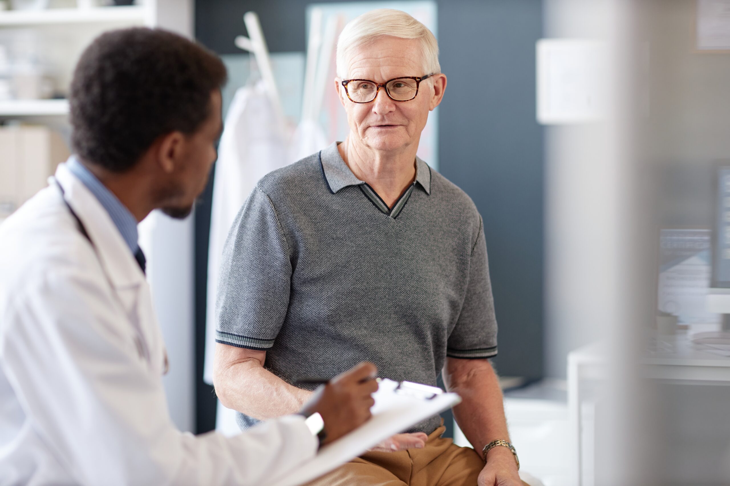 Patient smiling while discussing care with a clinician.